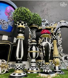 decorative vases and mirrors are on display in the grass