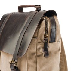 * Durable canvas and leather construction
 * Plenty of compartments
 * Adjustable-length straps Brown Leather Backpack, Rugged Men, Arctic Blue, Cool Backpacks, Blue Canvas, Designer Backpacks, Dark Brown Leather, Men's Backpack, Charcoal Gray