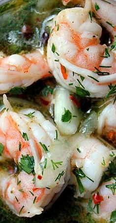 some shrimp is being cooked and garnished with parsley