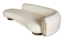 a white couch sitting on top of a wooden table