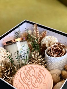 a box filled with pine cones and candles