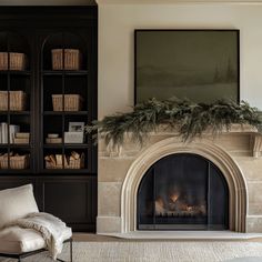 a living room filled with furniture and a fire place in front of a book shelf