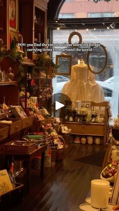 a room filled with lots of different types of clothing and accessories on display in front of a window