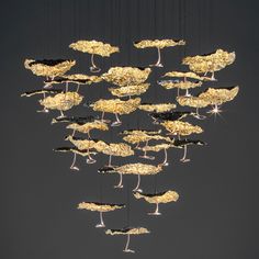 a chandelier hanging from the ceiling in front of a blue sky with birds on it