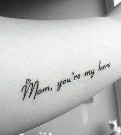 a woman's arm with the words mom, you're my hero on it