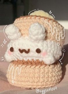 a small crocheted hat with a face on it