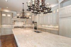 a large kitchen with an island and chandelier