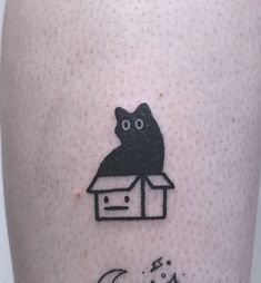 a black cat sitting on top of a box with the word love written below it