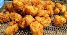 fried food sitting on top of a metal tray