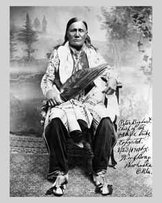 an old black and white photo of a native american man