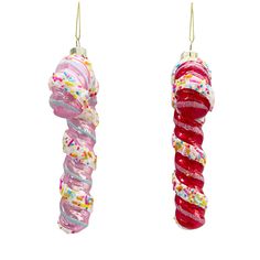 two donuts hanging from strings with sprinkles and icing on them