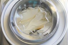 the inside of a washing machine filled with white cloth