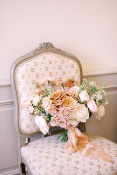 a bouquet of flowers sitting on top of a chair