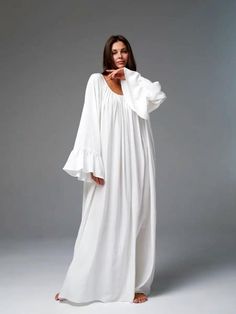 Bohemian Maxi Dress | Relaxed White Flowy Gown Embrace effortless elegance with this stunning bohemian-style maxi dress. Featuring a relaxed, oversized fit, this gown is perfect for those who value both comfort and style. The flowing silhouette and delicate gathers around the neckline create a soft and ethereal look, ideal for casual gatherings, beach events, or simply lounging in style. Details:     Color: Pure white     Relaxed, oversized fit for maximum comfort     Flowy, lightweight fabric t Bohemian Oversized Maxi Dress, Oversized Bohemian Maxi Dress, Bohemian Tunic Maxi Dress, Bohemian Billowy Maxi Dress, Elegant Relaxed Fit Maxi Dress For Vacation, Relaxed Fit Bohemian Tunic Maxi Dress, Bohemian Long Sleeve Billowy Maxi Dress, White Billowy Long Sleeve Maxi Dress, Oversized Linen Maxi Dress For Spring