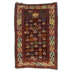 an antique persian rug with geometric design on red and blue ground, in the shape of a rectangle