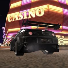 a black car is in front of a casino sign