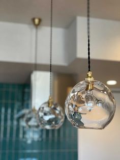 three glass globes hanging from the ceiling