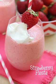 strawberry fresy in a glass with whipped cream and strawberries on the side