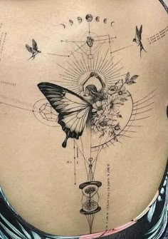 a woman's back with a butterfly and flower tattoo on her lower back side