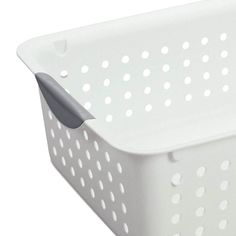 a white plastic basket with holes on the sides and handles, is shown in front of a white background