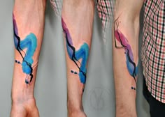 two men with matching tattoos on their arms and legs, one has a blue bird