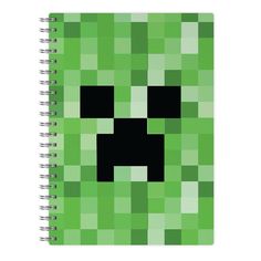 a green notebook with a black face on it