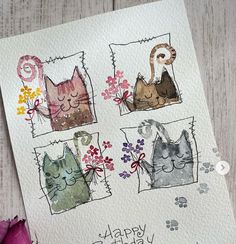 a card with three cats and flowers on it