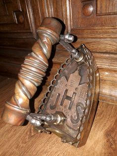 a close up of a metal object on a wooden floor