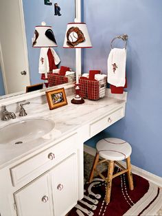 a bathroom with blue walls and red accents