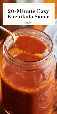 a mason jar filled with homemade enchilada sauce on top of a wooden table