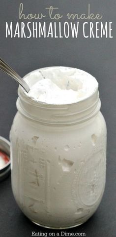 a jar filled with marshmallow creme next to a spoon on a table