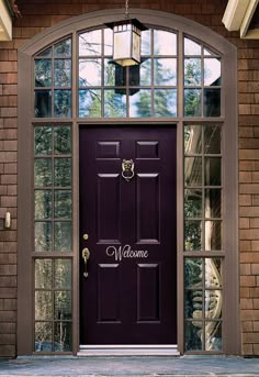 a purple door with three panes of different colors on it and the same color