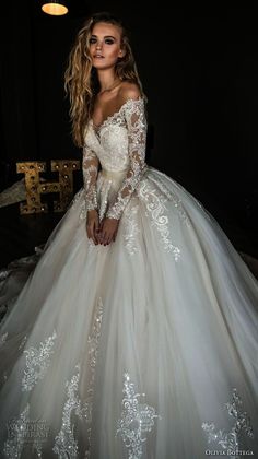 a woman in a wedding dress posing for the camera