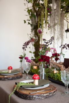 the table is set with plates and place settings