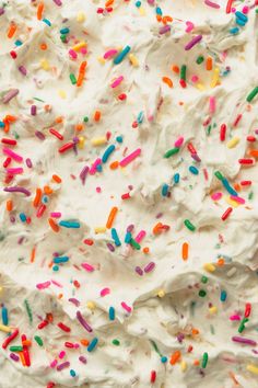 white frosted cake with colorful sprinkles on top