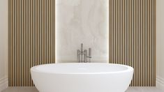 a large white bath tub sitting next to a wall