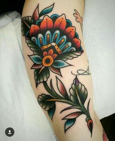 a colorful flower tattoo on the arm