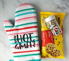 an oven mitt, cookie and candy bar on a counter