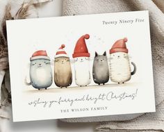 a card with three cats wearing santa hats