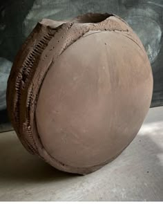 a clay vase sitting on top of a table