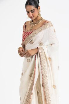 Ivory georgette lurex weave saree with scattered floral butti embroidery. Paired with a padded blouse, embroidered with gota, zari, dabka, beads and resham work.
Components: 2
Pattern: Embroidery
Type Of Work: Floral, Gota, Zari, Dabka, Beads
Neckline: Scoop Neck
Sleeve Type: Half Sleeves
Fabric: Georgette, Brocade
Color: Ivory
Other Details: 
Blouse:
Padded
Scallop trimmed edges
Back tie-up detailing with stones ornamentation
Occasion: Destination Wedding - Aza Fashions Elegant Resham Embroidered Slub Silk Pre-draped Saree, Elegant Slub Silk Pre-draped Saree With Resham Embroidery, White Chikankari Embroidery Blouse For Reception, White Blouse With Chikankari Embroidery For Reception, Elegant Tussar Silk Blouse With Dupatta, Elegant Slub Silk Blouse With Dupatta, Reception Blouse With Chikankari Embroidery In Traditional Drape, Off White Blouse Piece For Reception With Traditional Drape, Off White Traditional Drape Blouse Piece For Reception