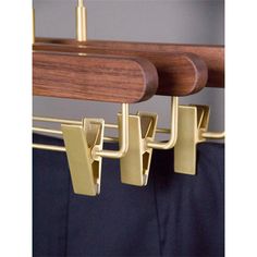 a coat rack with two coats hanging from it's sides and three hooks on each side