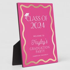 a pink and gold graduation party sign