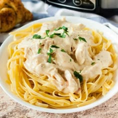 a white plate topped with pasta covered in gravy