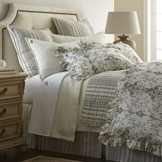 a bed with white and brown comforters in a bedroom