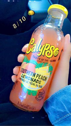 a bottle of calypse peach lemonade in someone's hand