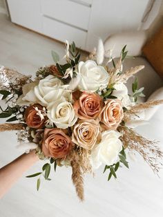 a bridal bouquet with peach and white flowers