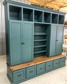 a large green cabinet with drawers and cupboards