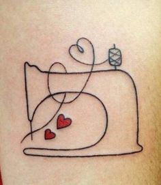 a tattoo on the back of a woman's thigh with hearts and a sewing machine