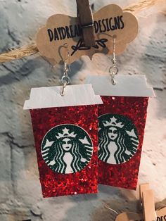 two starbucks cup earrings hanging from twine